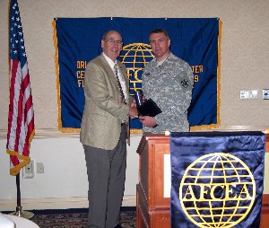 Col. Fred Eisele, USA (Ret.) (l), chapter vice president for programs, presents a chapter memento to Col. Pete Gallagher, USA, commander, Defense Information Systems Agency Central Field Command, and president of the Tampa-St. Petersburg Chapter, in appreciation of his presentation at the April meeting.